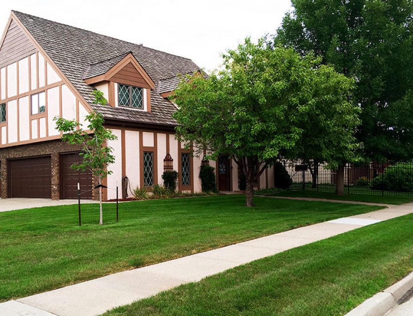 Front yard of a home with beautiful grass in front